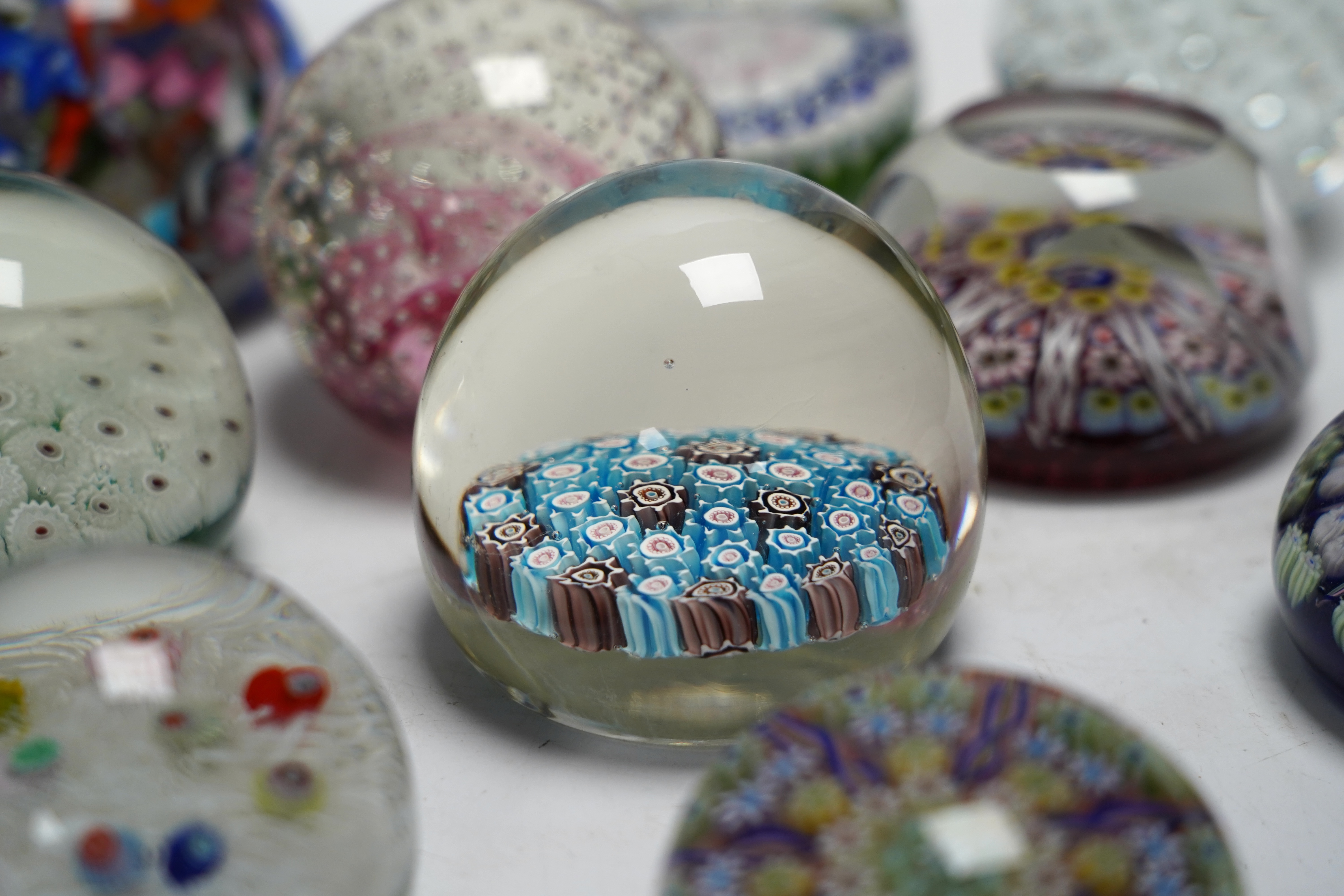 Eleven mixed Scottish and other glass paperweights including Caithness, largest 8.5cm in diameter